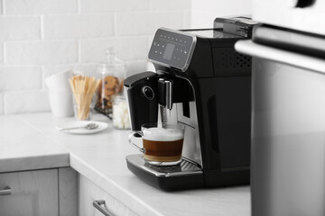 Sticker - Modern electric espresso machine making coffee with milk on white marble countertop in kitchen