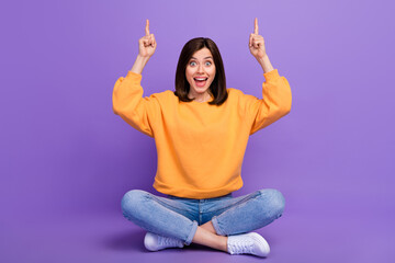 Wall Mural - full body length photo of young adorable excited girl fingers pointing empty space sitting celebrate