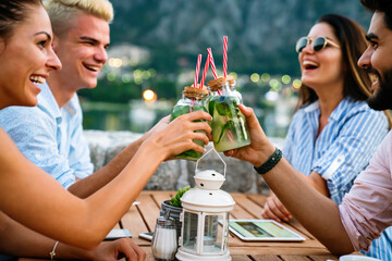 Wall Mural - Leisure holidays vacation people and food concept. Happy friends having dinner at summer party