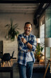 © bnenin - Smiling businessman posing for the camera, standing at his offic