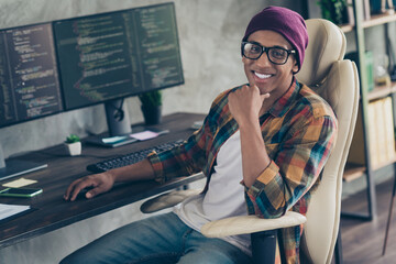 Photo of positive intelligent hardware expert sit chair arm touch chin microsoft workplace office indoors