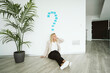© Westend61 - Businesswoman sitting on the floor in office with question mark above her