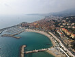 Aerial view of Menton in French Riviera from above. Drone view of France Cote d'Azur sand beach beneath the colorful old town of Menton. Small color houses near the border with Italy, Europe.