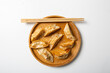 Overhead view of pan fried asian food gyoza and wooden chopsticks