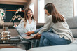 © standret - Sitting together. Woman helping couple with choosing the sofa and bed in the store