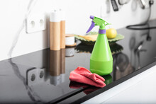 Close-up photo of bottle spray and rag are on the table in the kitchen. Household and cleaning concept