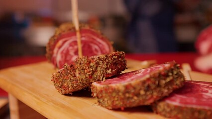 Wall Mural - Close up of row beef roulade cuts with skewers on a wooden cutting board. Barbecue preps seasoned with pepper mix. Cooking conept.