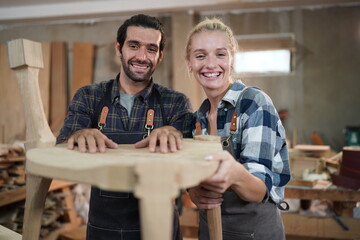 Contemporary Carpenter Working, Portrait of modern carpenter making wood furniture while working in joinery lit by sunlight with factory background on small business concept, copy space