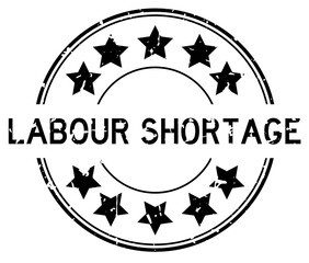 Sticker - Grunge black labour shortage word with star icon round rubber seal stamp on white background