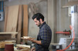 © FotoArtist - Carpenters Assembling Furniture, Small business in wood DIY workplace office background