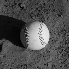 Sticker - Baseball ball on infield dirt in black and white.