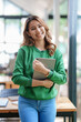 © amnaj - Young Asian business woman standing with her tablet working confidently and happily.
