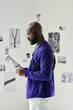 © AnnaStills - African young man reading booklet while visiting exhibition at art gallery