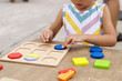 © Victor Mulero - Little girl making colorful wooden puzzle