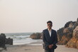 © BALLJINDER - man wearing sui posing near beach