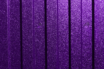 Natural abstract background of textured metallic wall, of purple color.