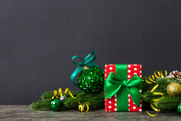 Wall Mural - New Year Christmas mood, gift box, branches of a christmas tree, New Year decorations on a colored background
