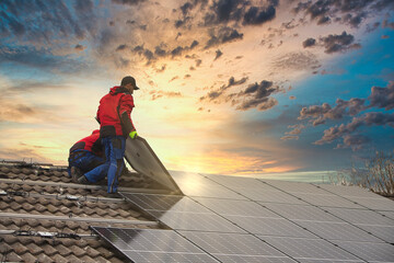 installing solar photovoltaic panel system. solar panel technician installing solar panels on roof. 