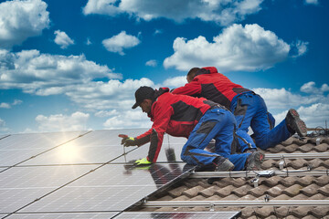 Installing solar photovoltaic panel system. Solar panel technician installing solar panels on roof. Alternative energy ecological concept.

