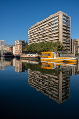 Wall Mural - Paris, France - 11 08 2022: La Villette Park. View of the Canal of the Basin of the villette with reflections of buildings