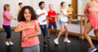© JackF - Cute smiling preteen girl exercising with group of children in choreography class