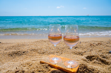 Cold rose wine from Provence served outdoor on white sandy beach Plage de Pampelonne near Saint-Tropez, France