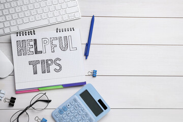 Helpful Tips. Flat lay composition with notebook, calculator and computer keyboard on white wooden table, space for text