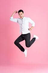 Wall Mural - Asian man full body image, isolated on pink background