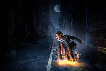 Wall Mural - Determined businessman leaving fire trails on asphalt