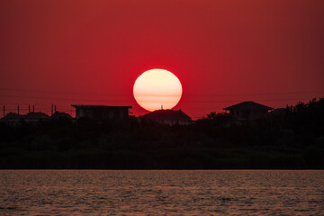 Wall Mural - The sun goes down over a lake