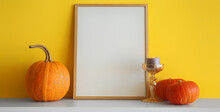Blank Photo Frame With Halloween Pumpkins And Candle On Table Near Yellow Wall