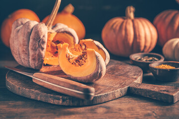 Wall Mural - Pieces with ripe pumpkin seeds on a cutting board