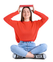 Wall Mural - Young woman in red sweater with book sitting on white background