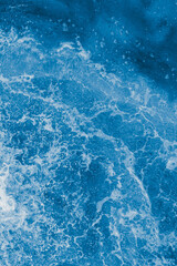 Wall Mural - Dark blue sea surface with waves, splash