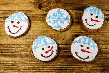 Wall Mural - Christmas gingerbread cookies on a wooden background. Top view