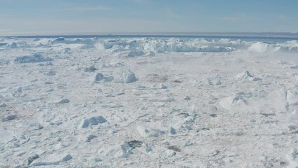 Wall Mural - Icebergs drone aerial video top view - Climate Change and Global Warming - Icebergs from melting glacier in icefjord in Ilulissat, Greenland. Arctic nature ice landscape in Unesco World Heritage Site.