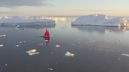 Wall Mural - Sail boat cruising among ice bergs during dusk, Disko Bay, Greenland.
Midnight sun, romantic view.
Climate change and global warming