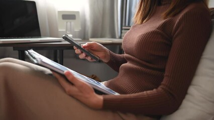 Woman hand using smart phone laptop and tablet with social network diagram on desk as concept in morning light.