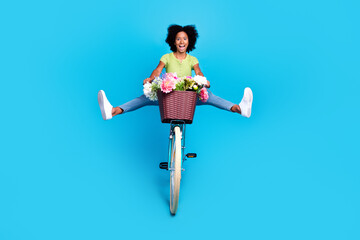 Wall Mural - Full body size photo of little positive excited schoolkid girl driving bicycle legs raising high speed playful good mood isolated on bright blue color background