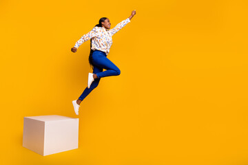 Wall Mural - Full length body size view of attractive cheerful girl jumping training isolated over bright yellow color background