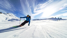 Professional Skier Skiing On Slopes In The Swiss Alps Towards The Camera