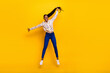 © deagreez - Full length body size view of attractive cheerful girly girl jumping holding tail isolated over bright yellow color background