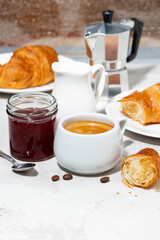 Wall Mural - cup of espresso and fresh croissants, berry jam for breakfast, vertical