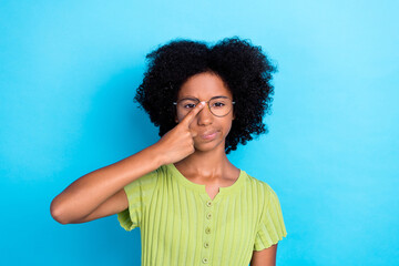 Canvas Print - Portrait of funky playful clever girl with wavy hairdo dressed green t-shirt finger touch eyewear isolated on blue color background