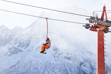 Wall Mural - People are lifting on open lft high up in Caucasus mountains