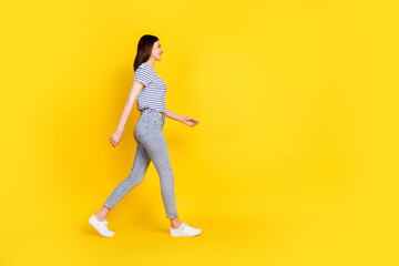 Poster - Full size profile photo of gorgeous satisfied lady walking toothy smile look empty space isolated on yellow color background