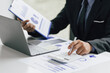 © Wasan - Business accountants are analyzing business market growth reports and making investment plans. Budget allocation, accounting and financial planning.