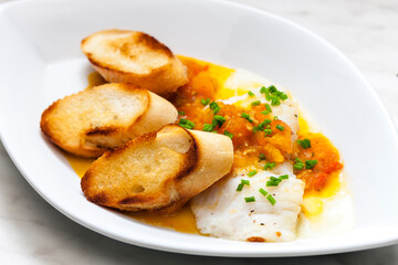 Wall Mural - white fish with tomato sauce and roasted baguette slices