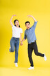 © Q88 - full body image of asian couple posing on yellow background