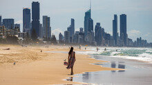 Beautiful Long-haired Girl In Long Colorful Dress Walks Along Beach In Gold Coast On Sunny Day; Beach With Huge Skyscrapers; Miami Beach In Gold Coast, Australia
